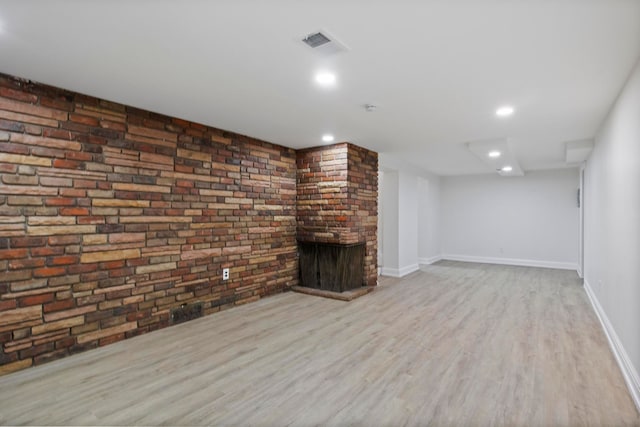 unfurnished living room with visible vents, wood finished floors, recessed lighting, a fireplace, and baseboards