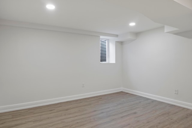 below grade area featuring recessed lighting, baseboards, and light wood-type flooring