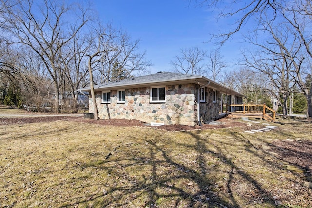 exterior space featuring stone siding and a deck