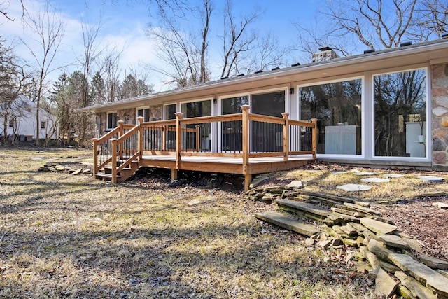 back of property featuring a chimney and a wooden deck