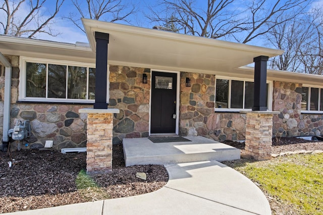 entrance to property featuring stone siding