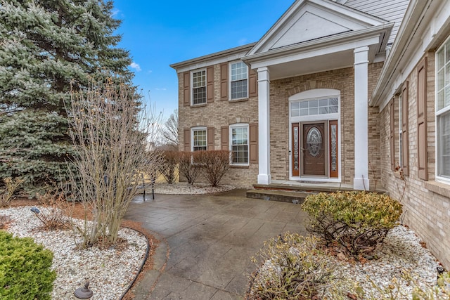 property entrance with brick siding