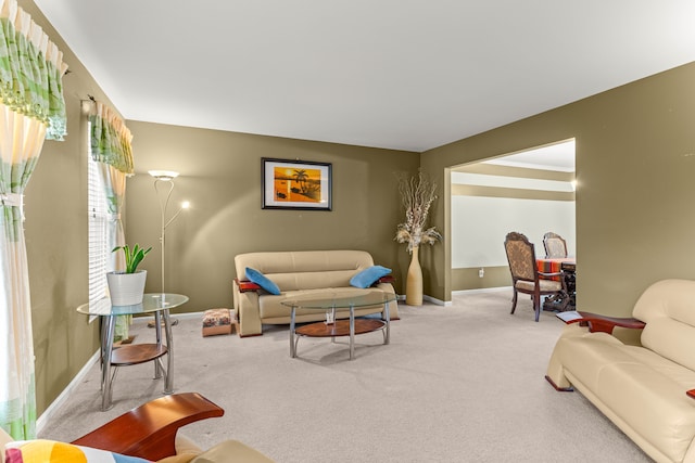 living room with baseboards and carpet flooring