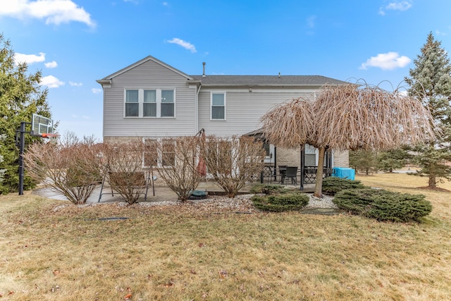 rear view of property featuring a patio and a lawn