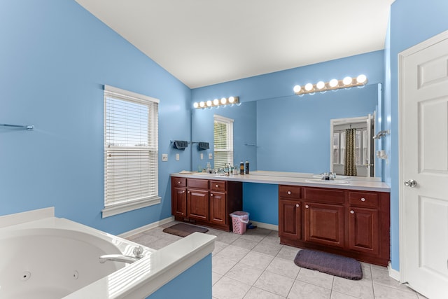 full bath featuring double vanity, a sink, vaulted ceiling, tile patterned floors, and a jetted tub