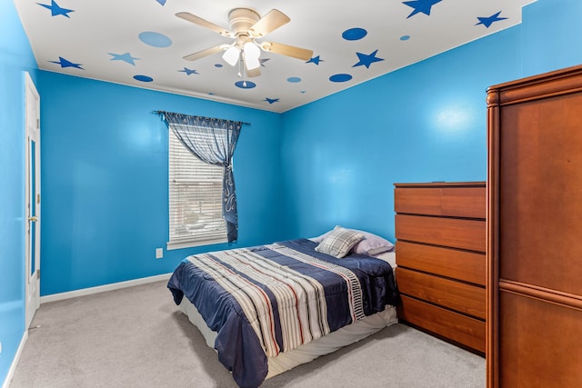 bedroom with carpet flooring, a ceiling fan, and baseboards