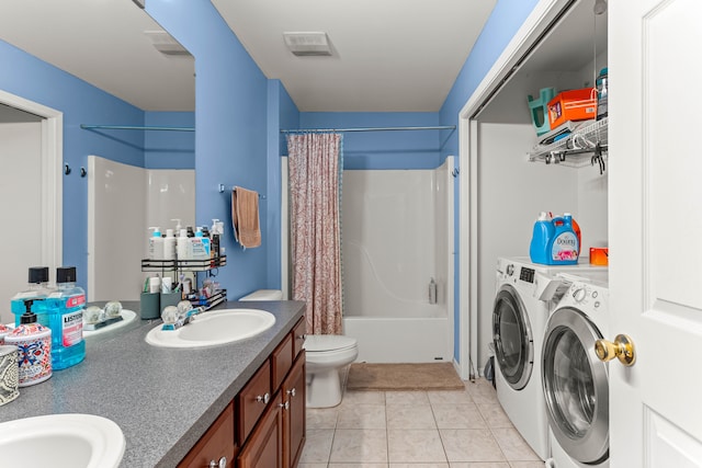 bathroom with separate washer and dryer, a sink, shower / bath combo with shower curtain, tile patterned floors, and toilet