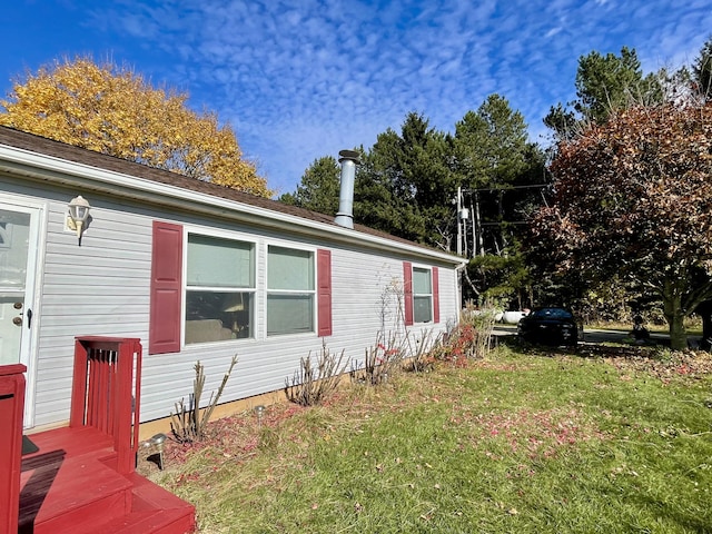 view of home's exterior with a yard