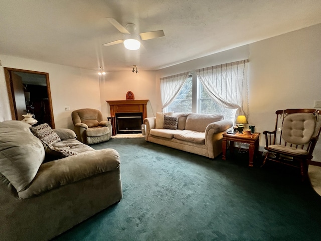 carpeted living room with a fireplace and ceiling fan