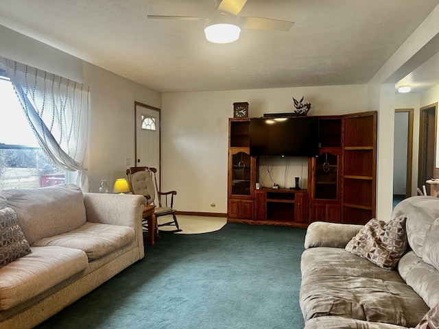 living room with carpet, baseboards, and ceiling fan