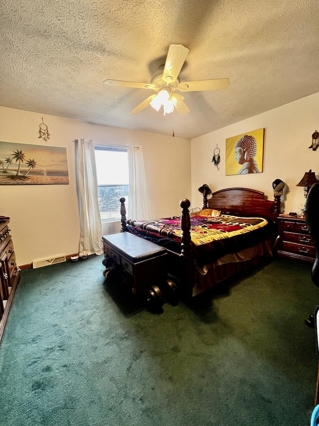 bedroom featuring a ceiling fan, dark colored carpet, and a textured ceiling