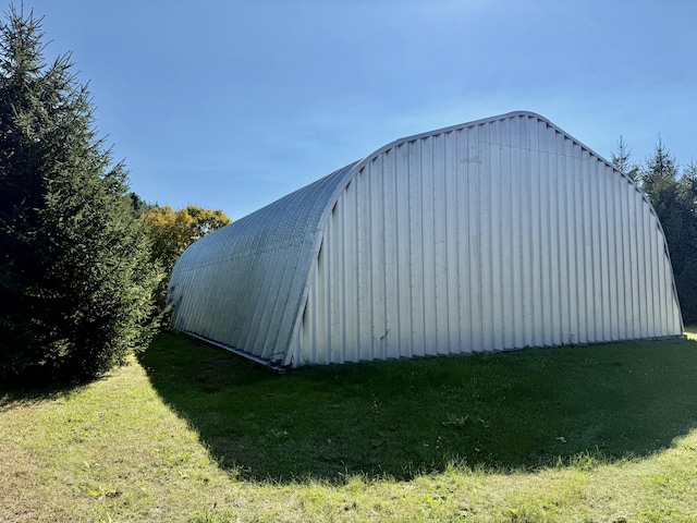 view of pole building with a lawn