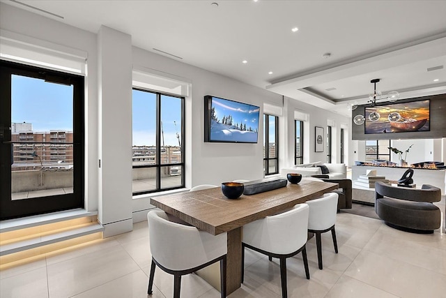 dining area featuring a wealth of natural light, a tray ceiling, recessed lighting, and light tile patterned floors