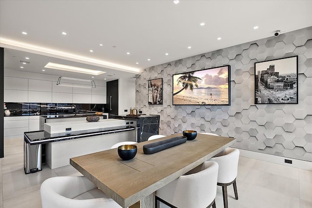 dining space with light tile patterned floors, recessed lighting, and tile walls