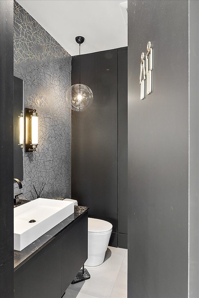 bathroom with vanity, tile patterned floors, toilet, and wallpapered walls