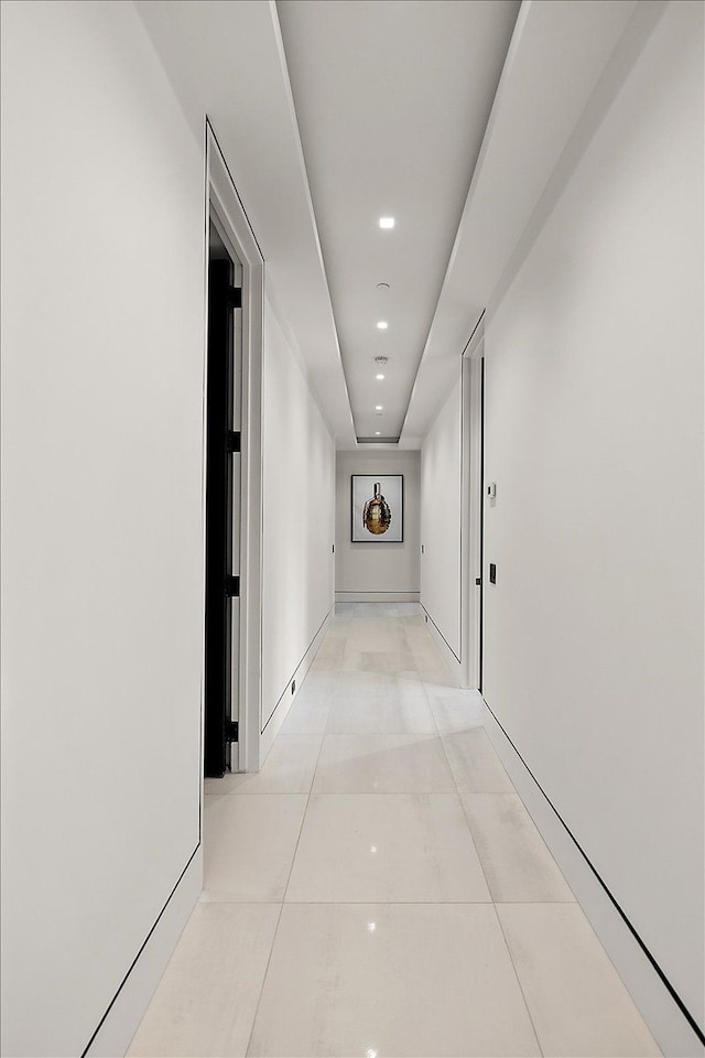 hallway featuring light tile patterned flooring, recessed lighting, and baseboards