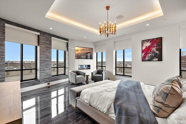 bedroom with a chandelier, visible vents, recessed lighting, and a tray ceiling