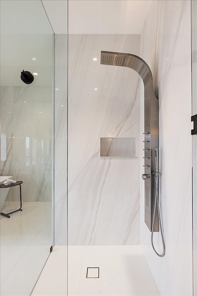 full bath with a marble finish shower