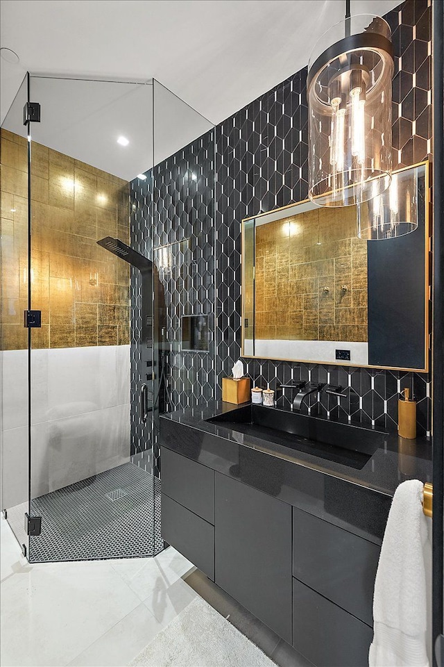 bathroom with vanity, tile walls, and a shower stall