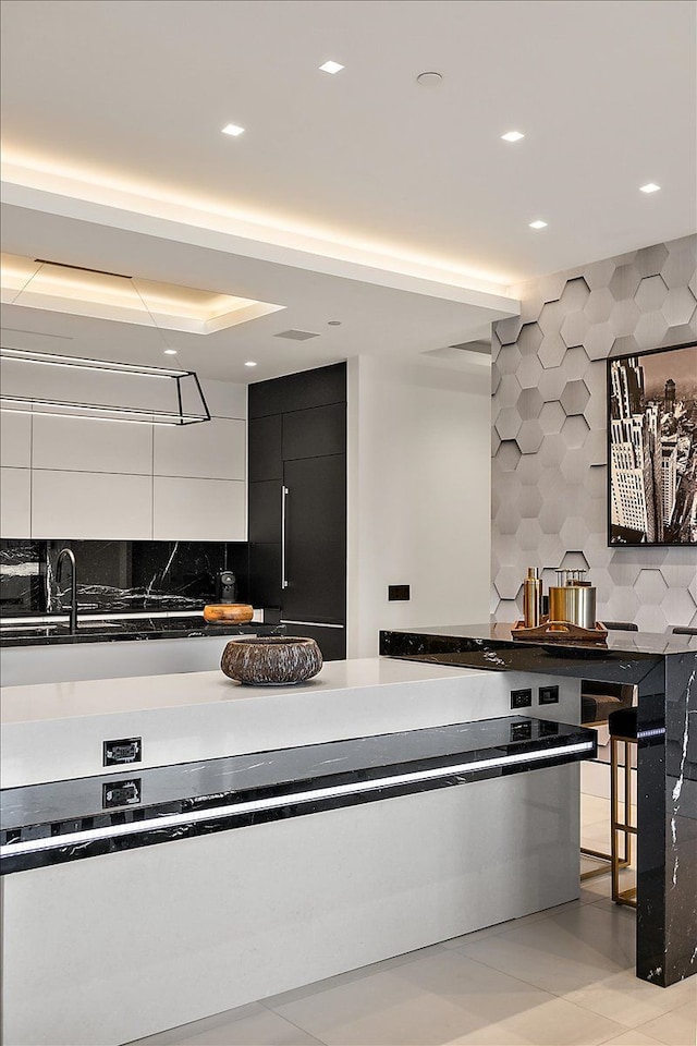 kitchen featuring dark cabinetry, recessed lighting, dark countertops, modern cabinets, and backsplash