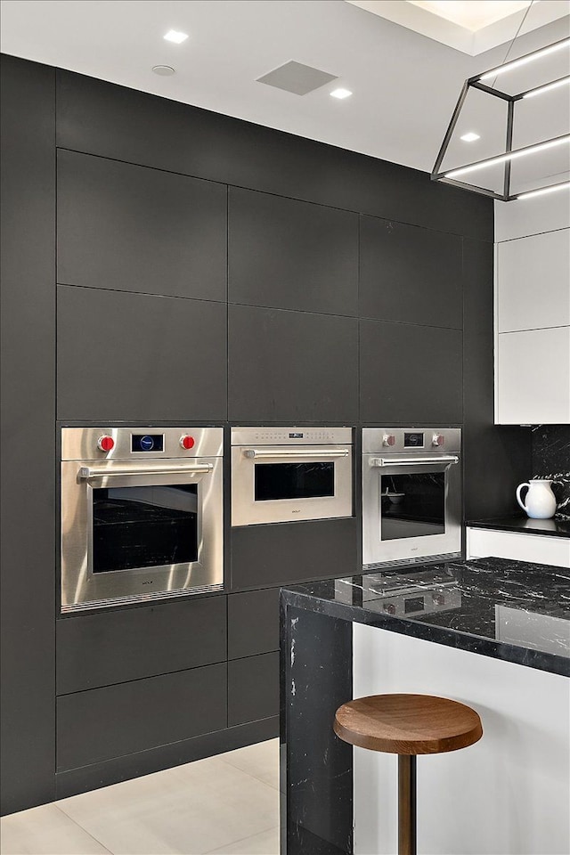 kitchen featuring modern cabinets, oven, and stainless steel oven