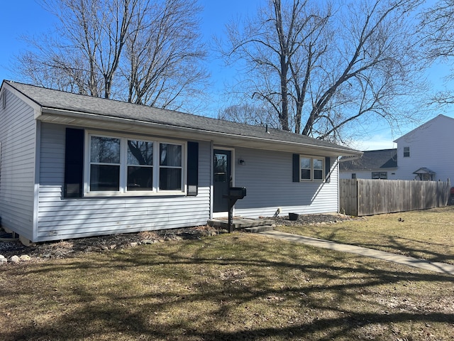 view of front of property with a front lawn and fence