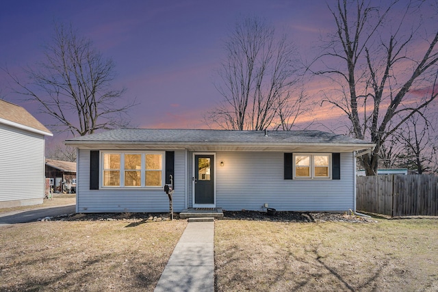 view of front of property with a front lawn and fence