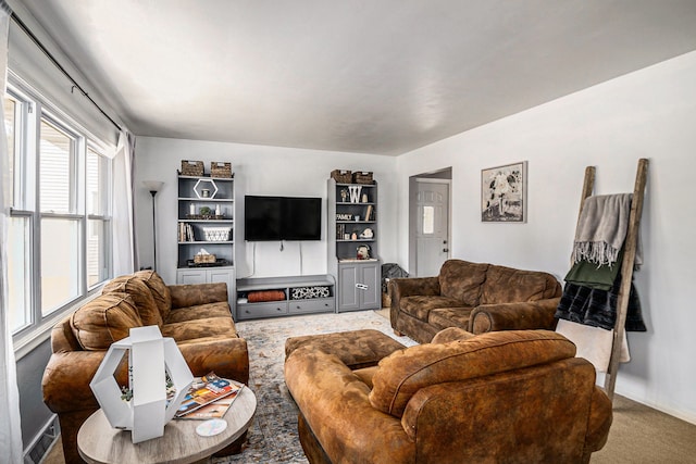 carpeted living room featuring baseboards