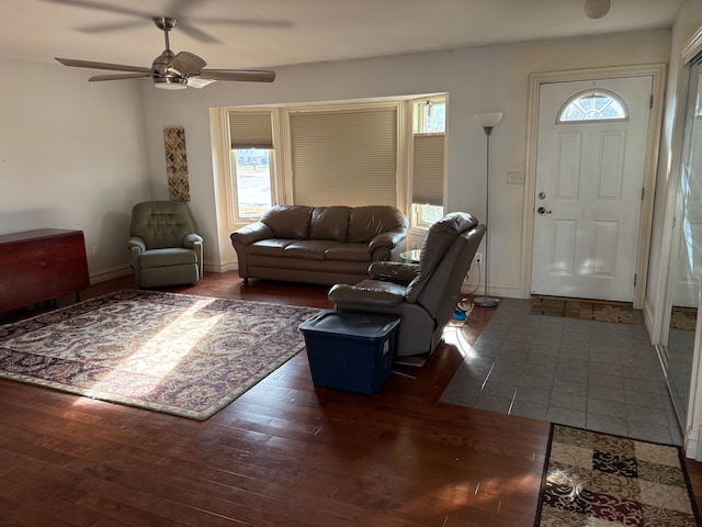 living area with ceiling fan, baseboards, and hardwood / wood-style floors