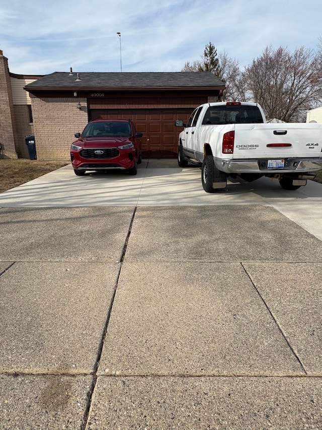 view of parking / parking lot with concrete driveway