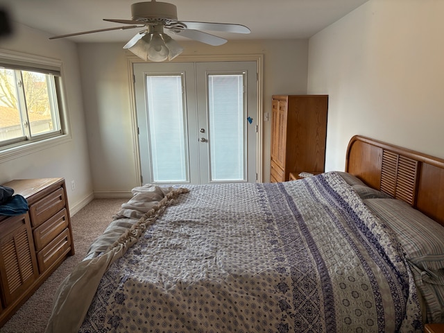 bedroom featuring a ceiling fan, light colored carpet, and baseboards