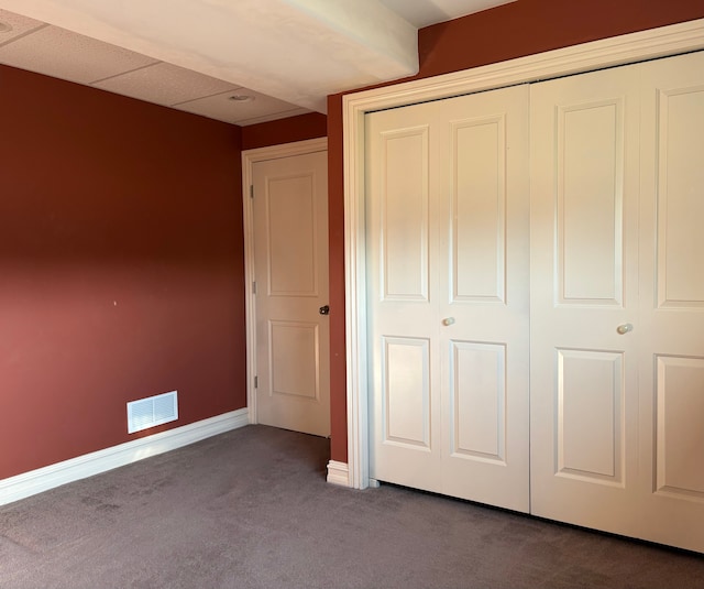 unfurnished bedroom featuring a closet, visible vents, carpet flooring, and baseboards