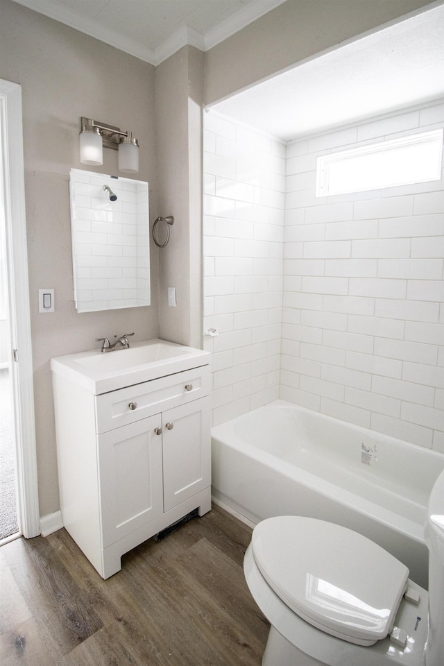 bathroom with  shower combination, ornamental molding, toilet, and wood finished floors