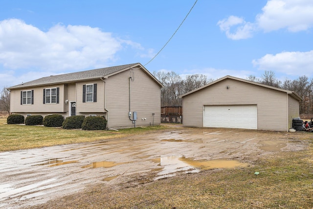 view of home's exterior featuring a yard, a detached garage, and an outdoor structure