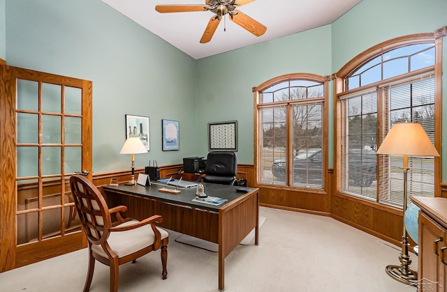 office area with carpet floors, ceiling fan, and wainscoting