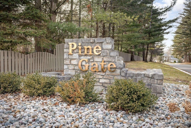 community / neighborhood sign with fence