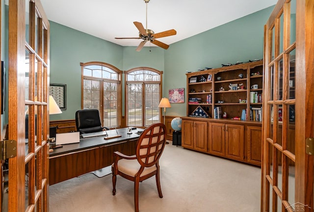 home office featuring light colored carpet and ceiling fan