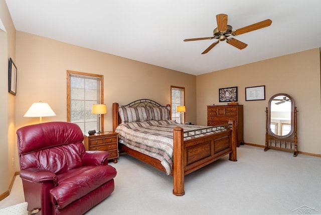 bedroom with light carpet, ceiling fan, and baseboards