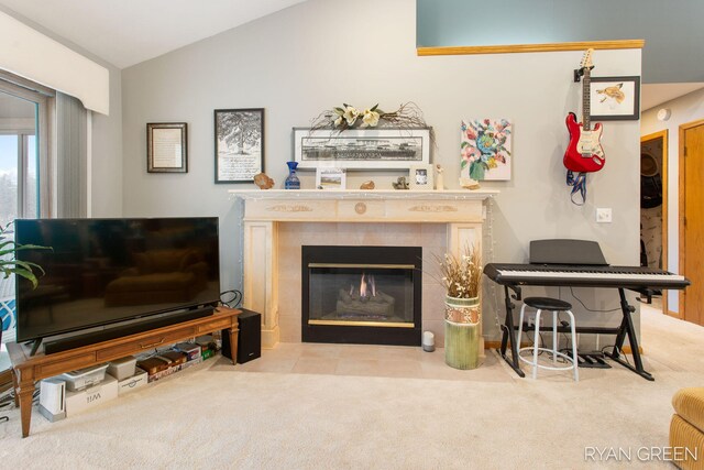 carpeted living area with vaulted ceiling and a fireplace