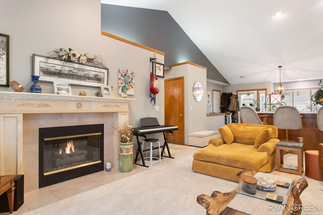 carpeted living room featuring high vaulted ceiling and a tile fireplace