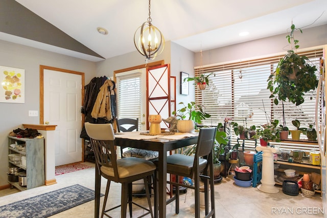 dining area featuring a chandelier and vaulted ceiling