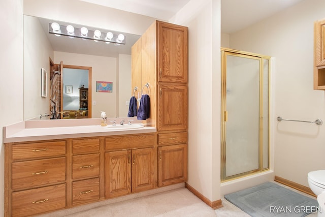 full bath with baseboards, a shower stall, toilet, and vanity