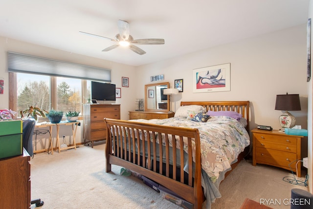 bedroom featuring a ceiling fan and light colored carpet