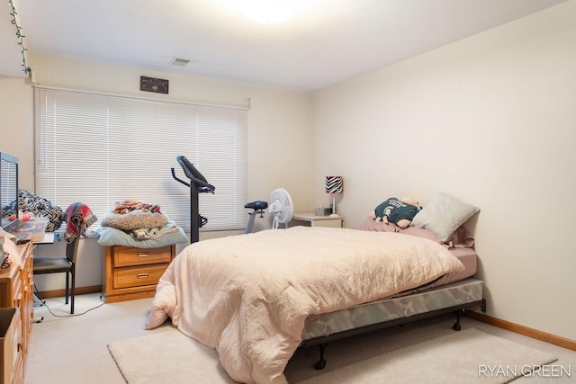 bedroom featuring baseboards and light colored carpet