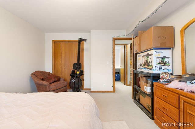 bedroom with light carpet, baseboards, and a closet