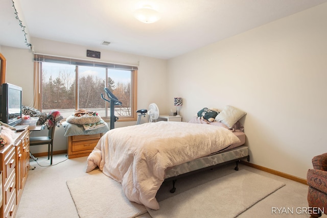 bedroom with baseboards, visible vents, and light colored carpet