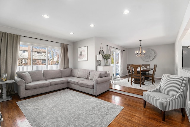 living area with recessed lighting, a notable chandelier, wood-type flooring, and plenty of natural light