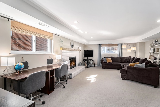 living room with visible vents, recessed lighting, a fireplace, and carpet floors