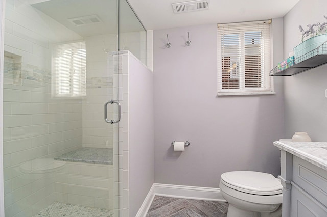 full bathroom with vanity, baseboards, visible vents, and a stall shower