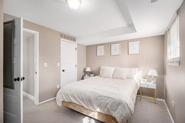 bedroom with light colored carpet, visible vents, and baseboards